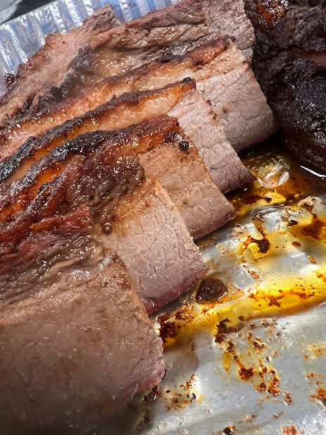 Tray of fresh chopped pork with Sunny Buns, sauce, and the Mike & Zach's BBQ logo